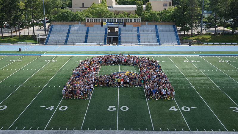 Students forming A on football field