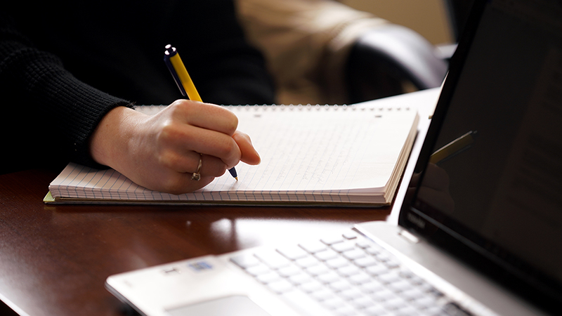 student taking notes