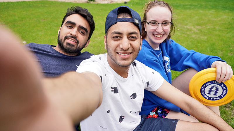 campus visitors hanging out on the quad