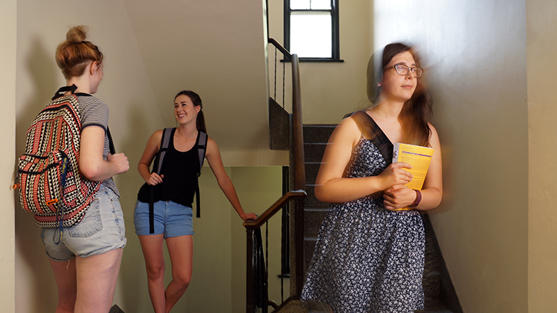 female students in dorm stairwell