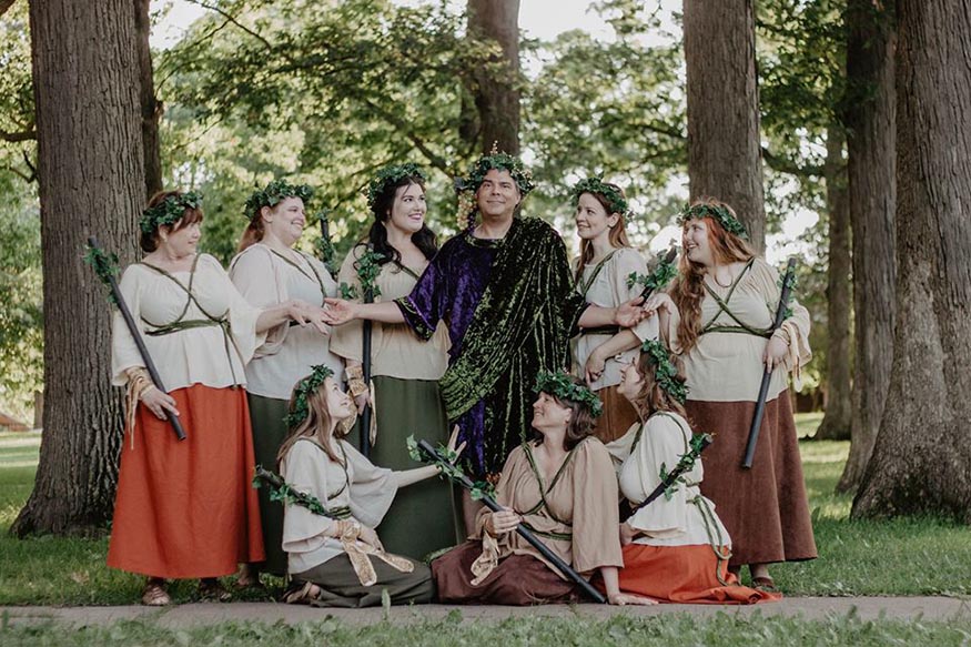 Dr. Hooker as Dionysus, surrounded by a throng of his devoted bacchae.