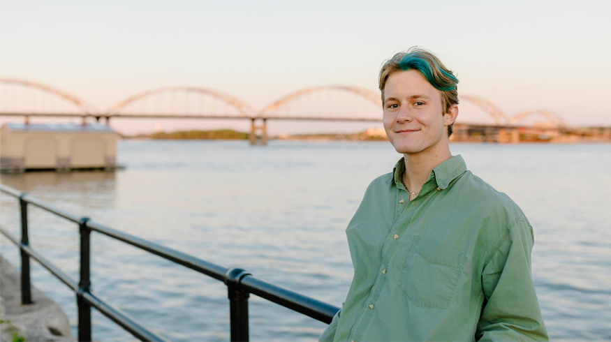 Adam poses near the Mississippi River in downtown Rock Island