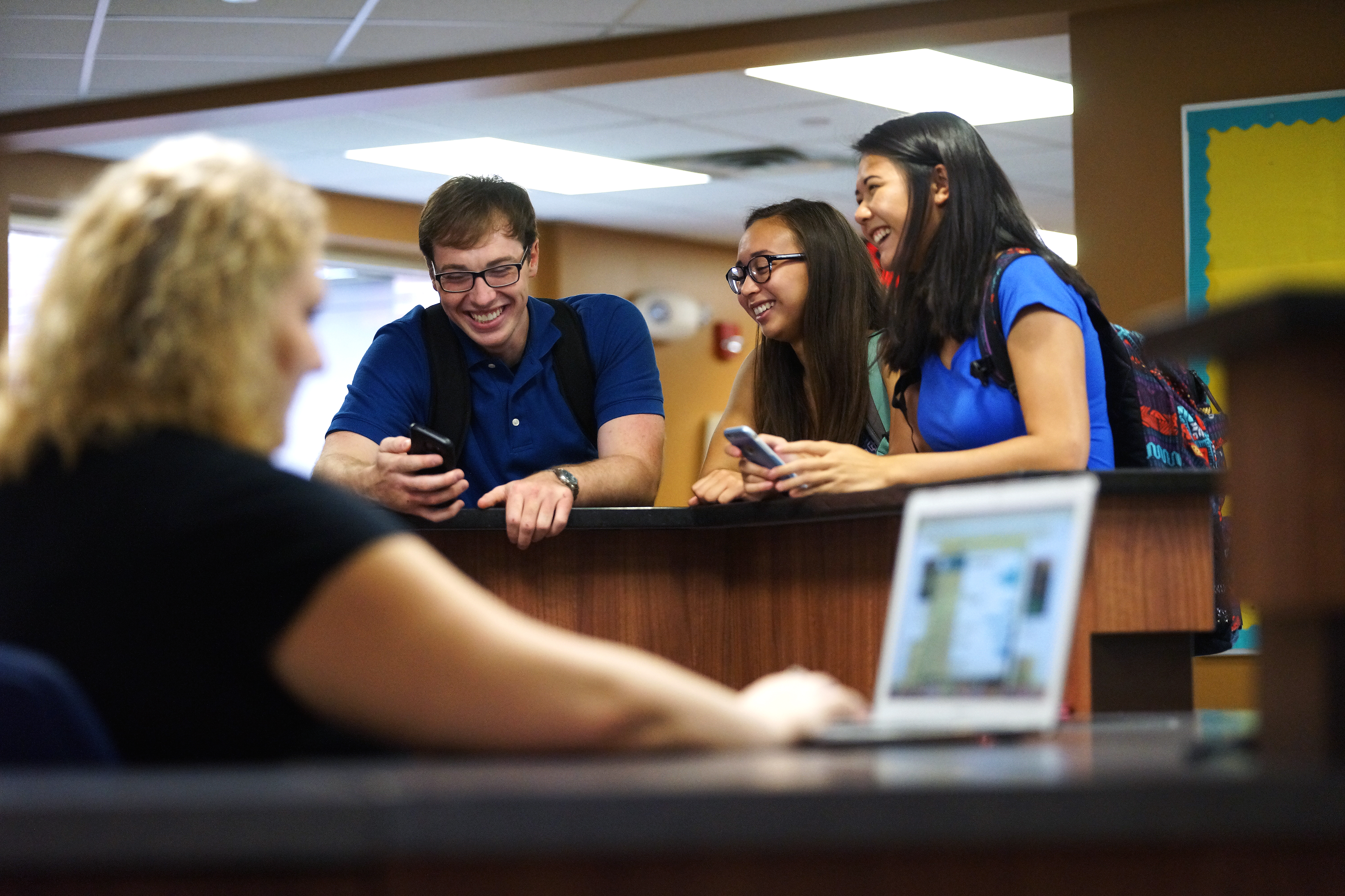 three students chatting in Swanson Hall