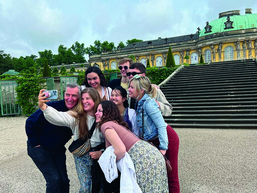Augustana Choir Director Dr. Jon Hurty and students outside Sanssouci Palace in Potsdam, Germany