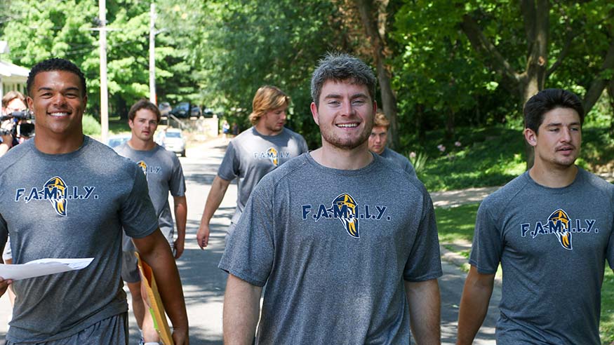 Football players in water line survey project