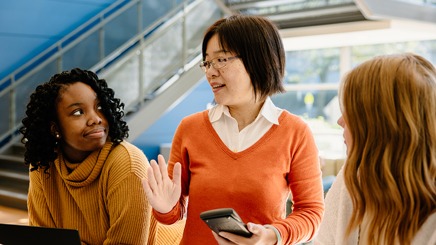 Students talking with a professor