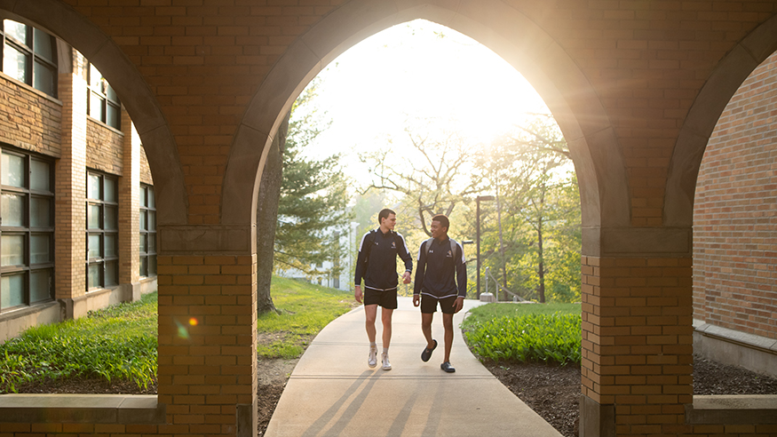 Two students walking on campus