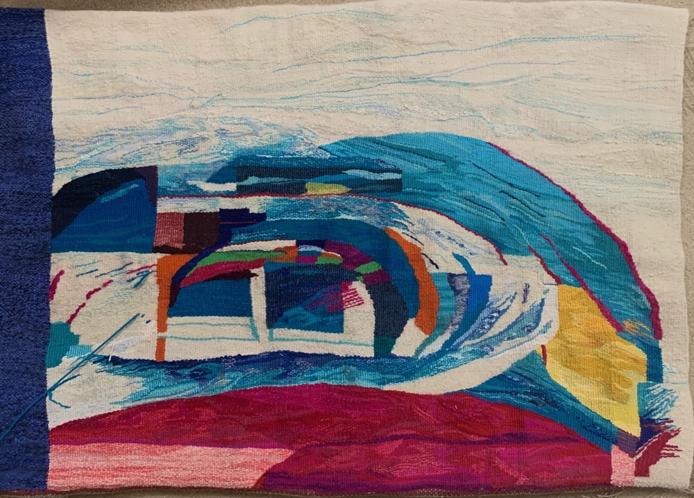 Tapestry with white, blue, green, red, and yellow threads