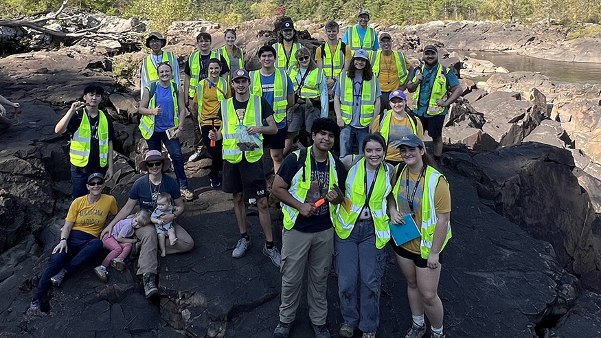 Students near a gneiss formation outside