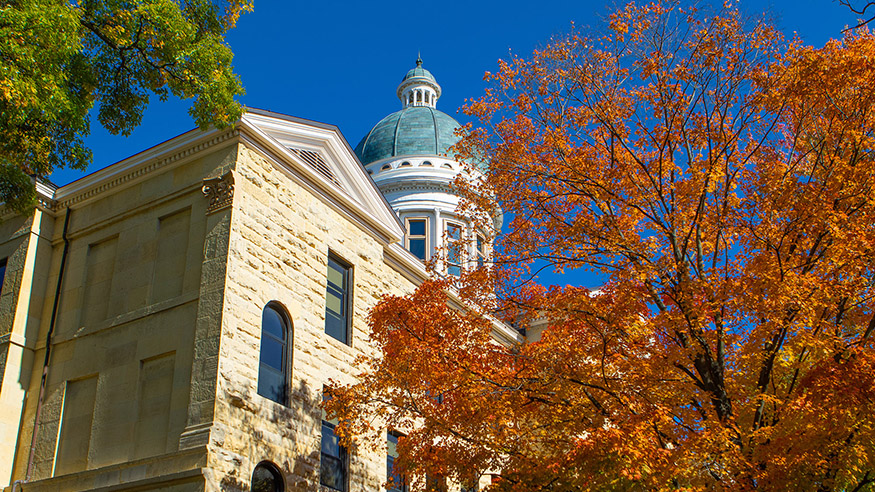 Photo of Old Main in the autumn, orange foliage