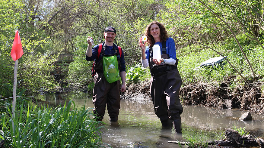 Dr. Kimberly Murphy with a student in a creek