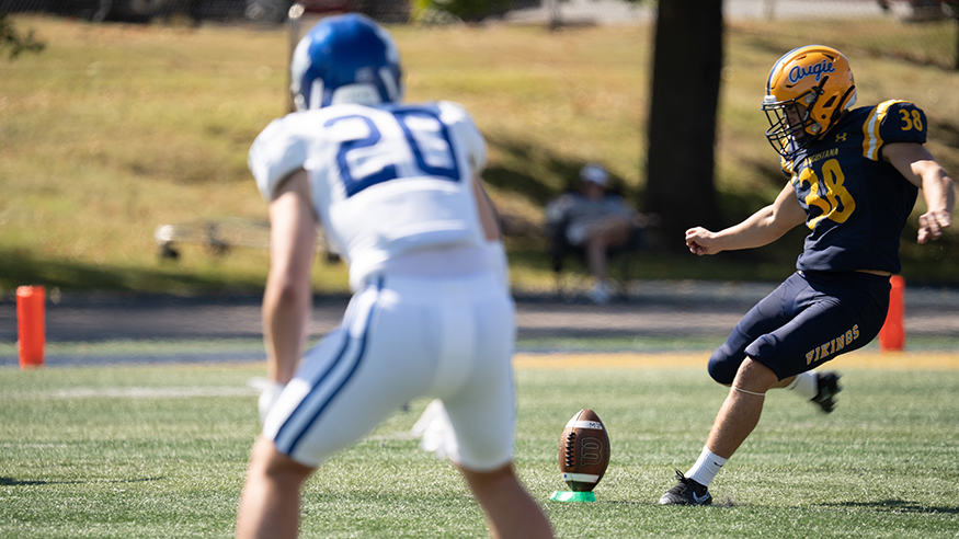A football player from the Vikings kicks the ball