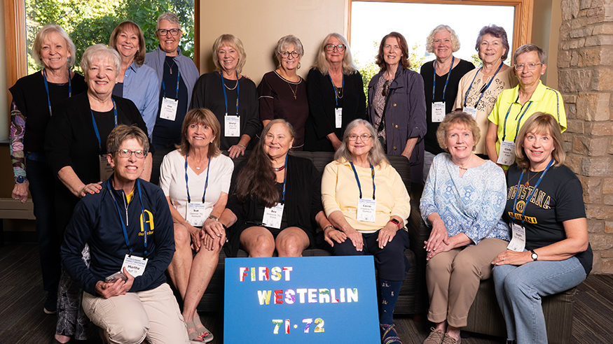 Members of the first group to live in Westerlin pose with a sign