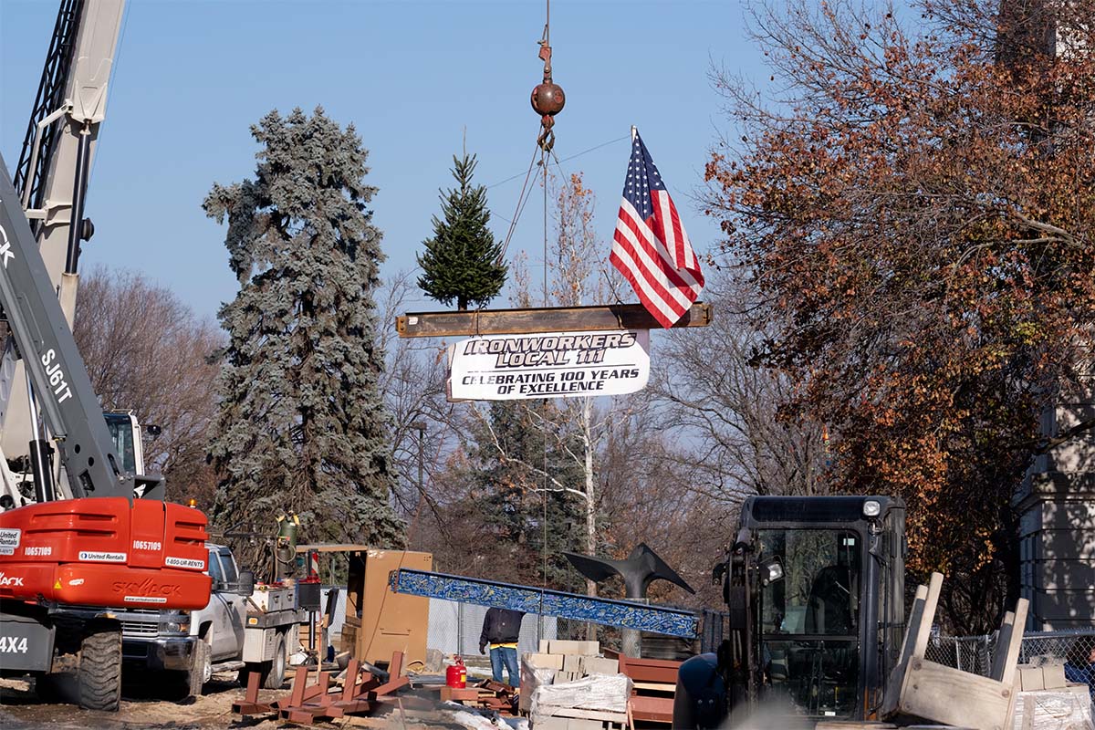 The last beam is lowered into the expanded Hanson Hall in the traditional "topping out" ceremony. 