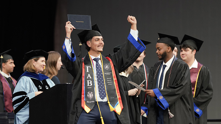 Student with arms up