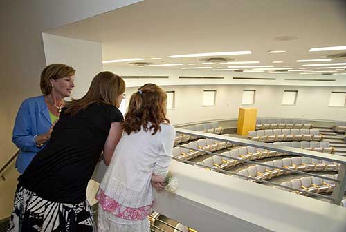 lisa wood and daughters look over a hall