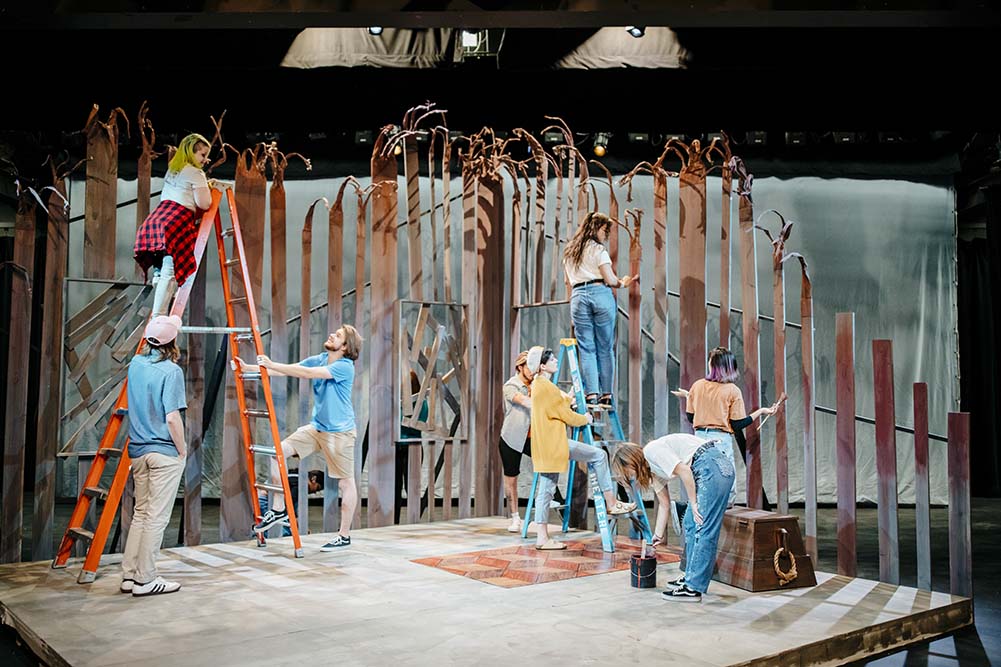 Studetmts building a set in the Brunner Theatre Center.