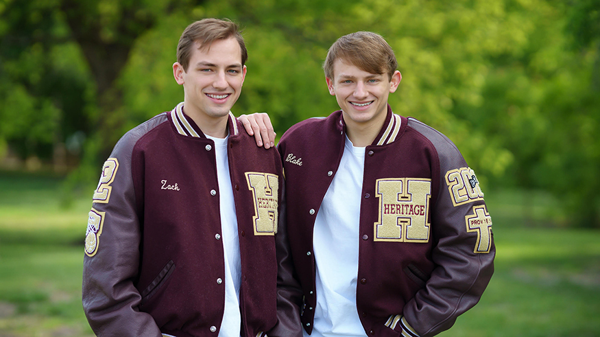 Twins Zach and Blake Benn pose for a photo in letterman's jackets.