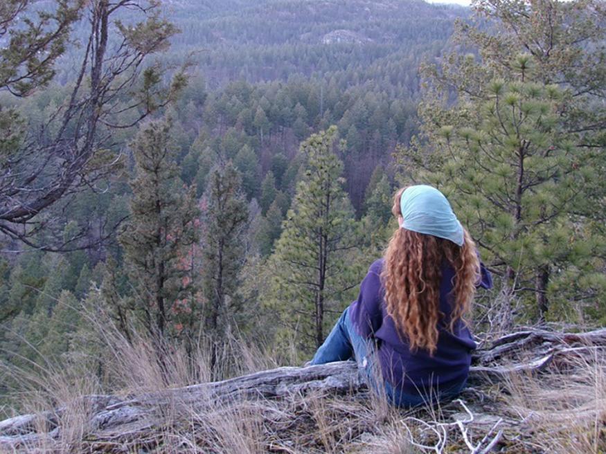 A student looking out over the mountain side