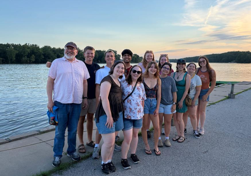a group of studetns smiling by the water