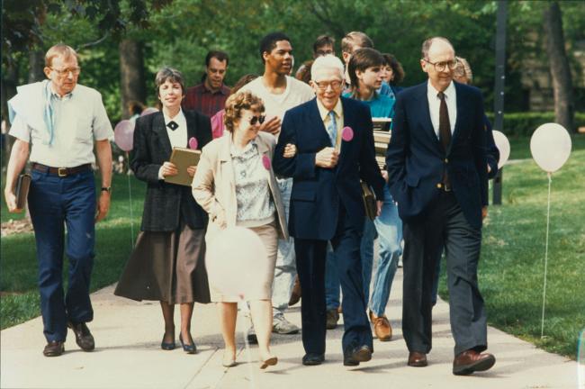 English professor Ann Boaden, Special Collections Librarian Judith Schadt-Belan, President Emeritus Conrad Bergendoff and President Thomas Tredway lead the procession of book-carriers from Denkmann to the new Library May 12, 1990. 
