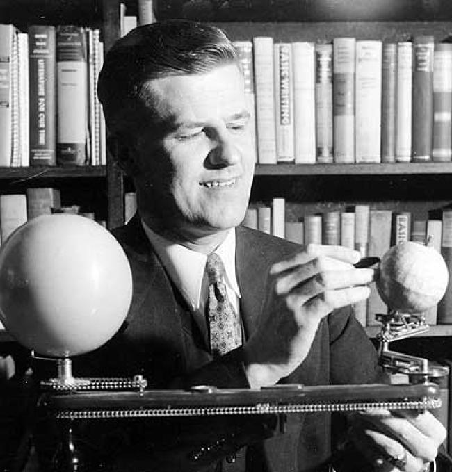 Harry E. Nelson with model planets.