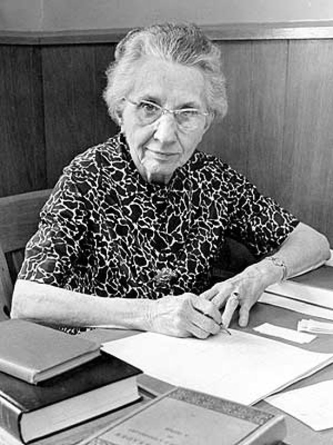 Margaret Olmsted, working at her desk in the 1960s.