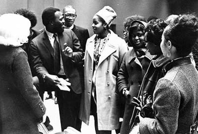 Roy Innis, chairman of the Congress on Racial Equality (CORE) speaks with students at a Black Power Symposium held at Augustana in February 1969.