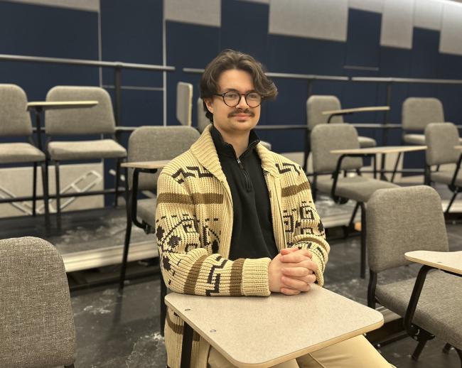 Luca Barba smiling for a photo in the classroom.