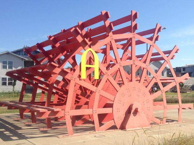 Augustana "A" sign on a wooden wheel