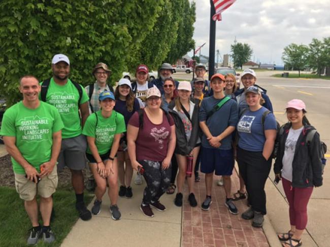 A group of students posing on a street in Geneseo