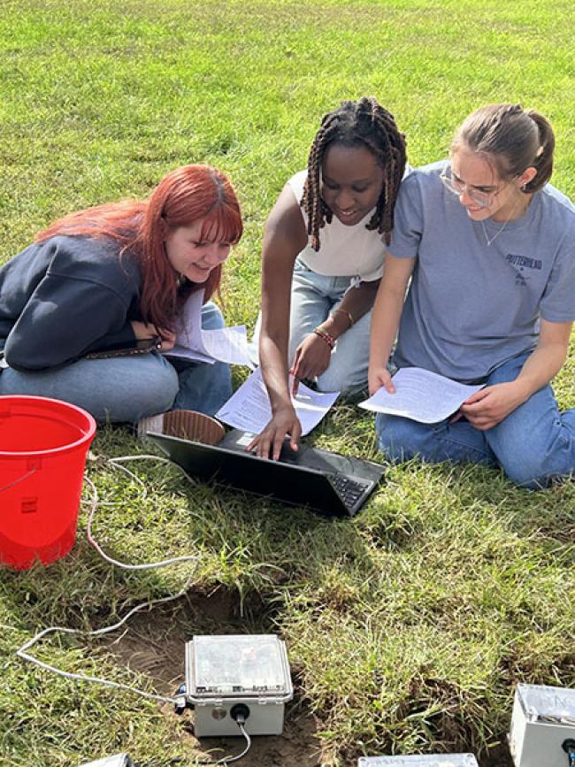 Three students with seismometer