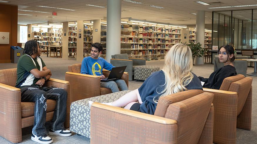 Four students gathered in a library