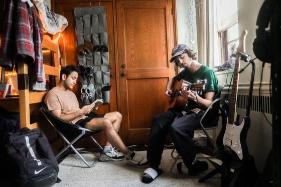 Two students sitting in a dorm room