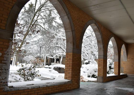Brick Archway with Snow covered sidewalk and trees