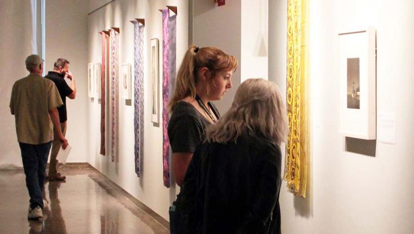 People looking at art in the Augustana Center for Visual Culture of Art main gallery